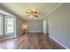 A well-lit bedroom featuring a bay window and fan, offering ample natural light and comfortable air circulation at 1309 Sweet Charm Ln, Knightdale, NC 27545