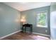 A simple bedroom with a window and wood-look floors is painted a gentle green at 1309 Sweet Charm Ln, Knightdale, NC 27545