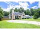 Lovely home featuring a well-manicured lawn, mature trees, and a charming exterior at 1309 Sweet Charm Ln, Knightdale, NC 27545