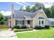 Charming home featuring black shutters, a well-maintained lawn, and inviting front yard landscaping at 1309 Sweet Charm Ln, Knightdale, NC 27545