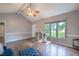 Well-lit living room with hardwood floors, vaulted ceilings, and large windows offering ample natural light at 1309 Sweet Charm Ln, Knightdale, NC 27545