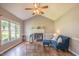Bright living room with vaulted ceiling, wood floors, fireplace, and large windows at 1309 Sweet Charm Ln, Knightdale, NC 27545