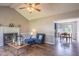 Comfortable living room featuring a fireplace, hardwood floors, and an open layout to the kitchen at 1309 Sweet Charm Ln, Knightdale, NC 27545