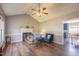 Cozy living room with a vaulted ceiling, fireplace, hardwood floors, and seamless flow to the kitchen at 1309 Sweet Charm Ln, Knightdale, NC 27545