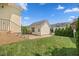 This backyard features a detached garage, lawn, brick patio, and privacy landscaping at 1330 Rodessa, Raleigh, NC 27607