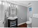 Charming bathroom with pedestal sink, ornate mirror, and neutral color scheme with natural light at 1330 Rodessa, Raleigh, NC 27607