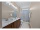 This full bathroom features a double sink vanity, tile floor, and tub shower at 1330 Rodessa, Raleigh, NC 27607