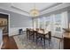 Elegant dining room with hardwood floors, decorative chandelier, and large windows at 1330 Rodessa, Raleigh, NC 27607