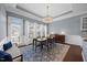 Elegant dining room with hardwood floors, decorative chandelier, and large windows at 1330 Rodessa, Raleigh, NC 27607