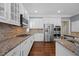 Modern kitchen featuring granite countertops, stainless steel appliances, and white cabinets at 1330 Rodessa, Raleigh, NC 27607