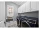 Well-organized laundry room with modern washer, dryer, sink, and storage cabinets at 1330 Rodessa, Raleigh, NC 27607
