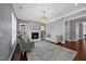 Bright living room featuring a fireplace, hardwood floors, and a decorative chandelier at 1330 Rodessa, Raleigh, NC 27607