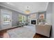 Bright living room featuring a fireplace, hardwood floors, and a decorative chandelier at 1330 Rodessa, Raleigh, NC 27607