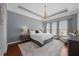Spacious main bedroom featuring a tray ceiling, chandelier, and three large windows for natural light at 1330 Rodessa, Raleigh, NC 27607