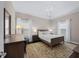This comfortable main bedroom has a bed, dresser, bedside tables, and chandelier at 1330 Rodessa, Raleigh, NC 27607