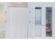 White bathroom featuring a tub and shower with a curtain, as well as a washer/dryer unit at 1405 Pennsylvania Ave, Durham, NC 27705