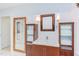 Bathroom vanity area with twin wooden cabinets, decorative mirrors, and good lighting at 1405 Pennsylvania Ave, Durham, NC 27705