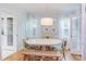 Elegant dining room featuring hardwood floors, a farmhouse-style table, and modern lighting at 1405 Pennsylvania Ave, Durham, NC 27705