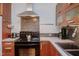 Close-up of a kitchen with stainless steel appliances and mosaic tile backsplash at 1405 Pennsylvania Ave, Durham, NC 27705