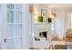Bright living room featuring a fireplace, white armchair, and French doors at 1405 Pennsylvania Ave, Durham, NC 27705