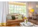 Comfortable living room with a large window, cozy seating, and natural light at 1405 Pennsylvania Ave, Durham, NC 27705