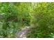 Secluded gravel path surrounded by lush landscaping and trees provides a tranquil experience at 1405 Pennsylvania Ave, Durham, NC 27705