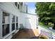 Back deck with outdoor seating and view of wooded backyard at 146 Greenmont Ln, Cary, NC 27511