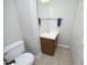 A well-lit bathroom features a single sink vanity, large mirror and neutral tile flooring at 146 Greenmont Ln, Cary, NC 27511