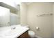 Bright bathroom featuring a white vanity, toilet, and shower with a neutral-colored curtain at 146 Greenmont Ln, Cary, NC 27511