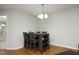 Dining area with a gray dining table, seating for four, and modern chandelier at 146 Greenmont Ln, Cary, NC 27511