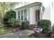 Charming townhome entrance with brick steps and vibrant flower accents at 146 Greenmont Ln, Cary, NC 27511