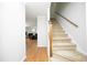 Hallway featuring hardwood floors and stairs leading to the upper level at 146 Greenmont Ln, Cary, NC 27511