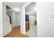Open hallway view leading to a bright kitchen and a glimpse of the staircase at 146 Greenmont Ln, Cary, NC 27511