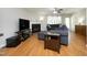 Cozy living room with a fireplace, plush blue sofa, and a ceiling fan at 146 Greenmont Ln, Cary, NC 27511