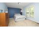 Main bedroom is painted light blue, with a darker blue accent wall and a large window at 146 Greenmont Ln, Cary, NC 27511