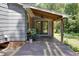 Cozy back porch with rocking chairs, ceiling fan, and a view of the backyard and garden at 1613 Euclid Rd, Durham, NC 27713