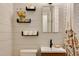 Updated bathroom featuring shiplap walls, floating shelves, modern fixtures, and a stylish shower curtain at 1613 Euclid Rd, Durham, NC 27713