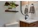 Modern bathroom with updated vanity, round mirror, and decorative shelving at 1613 Euclid Rd, Durham, NC 27713