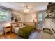 Cozy bedroom featuring hardwood floors, a ceiling fan, and a comfortable queen-sized bed at 1613 Euclid Rd, Durham, NC 27713