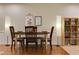 Dining room showcasing neutral walls, hardwood floors, modern lighting, and built-in shelving for ample storage at 1613 Euclid Rd, Durham, NC 27713