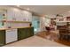 Open concept kitchen with wooden countertops transitions to dining and living area with hardwood flooring at 1613 Euclid Rd, Durham, NC 27713