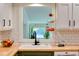 Kitchen features include wood counters, hanging fruit basket, white cabinets above, and green cabinets below at 1613 Euclid Rd, Durham, NC 27713