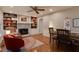 Cozy living area featuring built-in bookshelves, fireplace, neutral color scheme, and hardwood floors at 1613 Euclid Rd, Durham, NC 27713