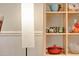 Close up of open shelving holding cups, pots, and other decorative items at 1613 Euclid Rd, Durham, NC 27713