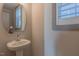 Powder room featuring a modern pedestal sink, stylish fixtures, and bright natural light at 1624 Tunnel St, Wendell, NC 27591