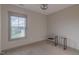 Neutral bedroom featuring carpeted floors, natural light from a large window, and minimal furnishings at 1624 Tunnel St, Wendell, NC 27591