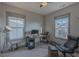 Bright bedroom featuring carpeted floors, two windows and ceiling fan with a desk and accent lighting at 1624 Tunnel St, Wendell, NC 27591