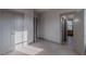 Bedroom with neutral carpet and an open doorway to the living room, creating an airy and inviting atmosphere at 1624 Tunnel St, Wendell, NC 27591