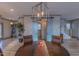Dining room with modern lighting and pale blue barn doors, creating an inviting atmosphere for meals at 1624 Tunnel St, Wendell, NC 27591