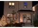 Festive two-story home adorned with holiday lights and decorations, highlighting its cozy front porch at 1624 Tunnel St, Wendell, NC 27591
